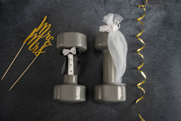 istock Wedding concept with gym dumbbells stylized as bride and groom. 1423523426