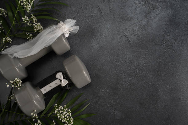 istock Wedding concept with gym dumbbells stylized as bride and groom. 1423523450