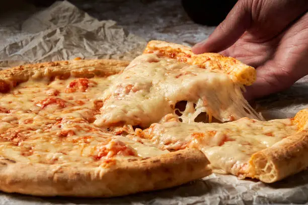 Italian pizza Margherita closeup with melting cheese
