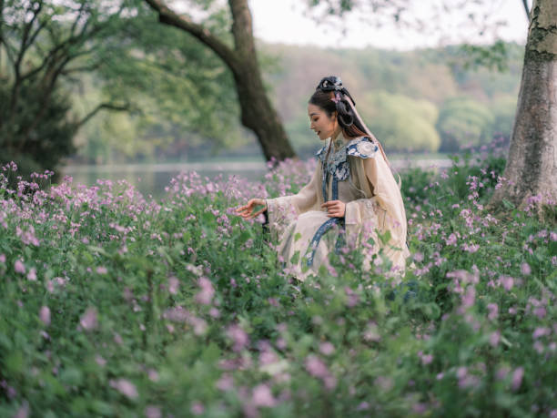 Girl wearing ancient Chinese clothes in beautiful park