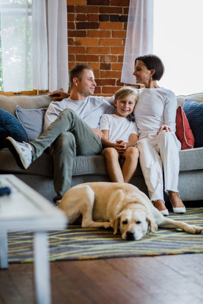 istock Couple looking at each other, cuddling their son who is joyfully smiling at camera 1423527180