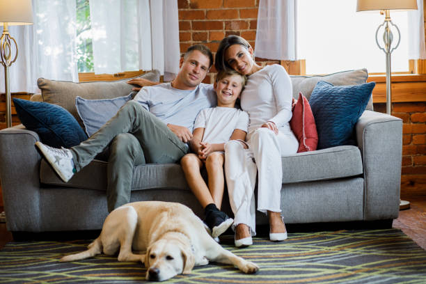 istock Happy married couple cuddling their son and smiling joyfully at camera 1423527181