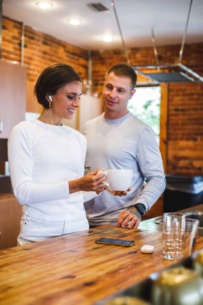 istock Couple having bonding moments while having morning coffee in the kitchen 1423527876