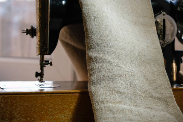 istock Hemp fabric and vintage manual sewing machine. Evening Golden Hour. 1423530160