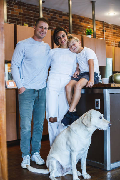 istock Happy small family cuddling and smiling at camera 1423530252