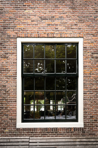 Wooden window in a brick wall