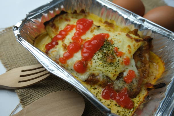 Lasagna with chili sauce on aluminum box