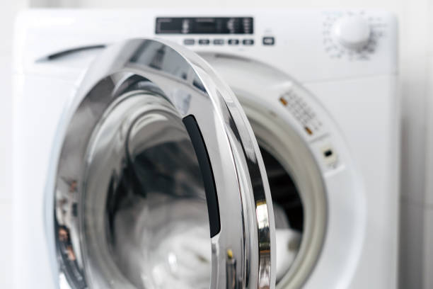 new washing machine with open door, closeup open door in automatic washing machine and clean clothes inside after laundry in apartment bathroom, modern domestic appliance dryer stock pictures, royalty-free photos & images