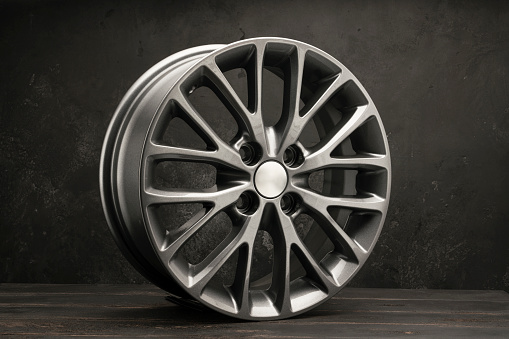 new grey allonew grey alloy wheels on a dark textured black background