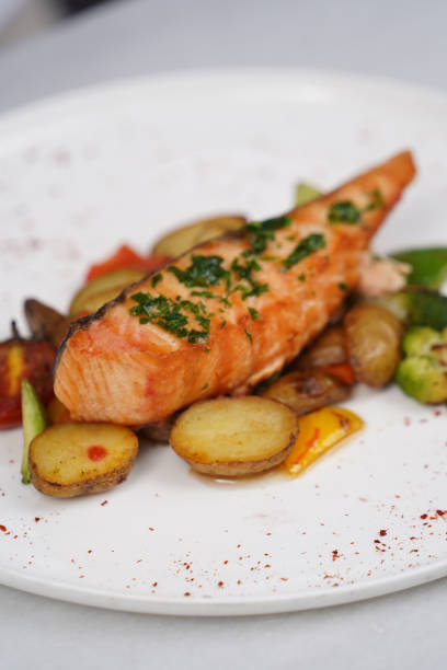 istock Grilled salmon and baked vegetable on a white plate 1423536816