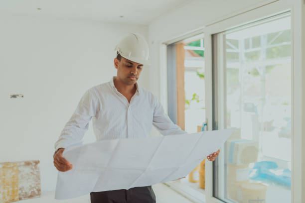 istock A architect looking at plan and thinking about working on big project. Building in construction process interior. 1423537078
