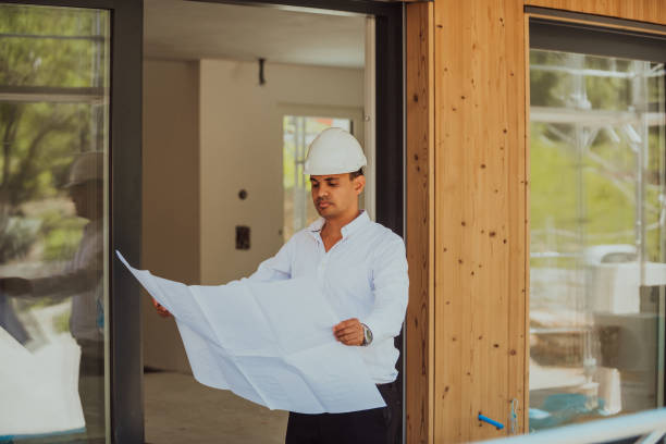 istock A architect looking at plan and thinking about working on big project. Building in construction process interior. 1423537098
