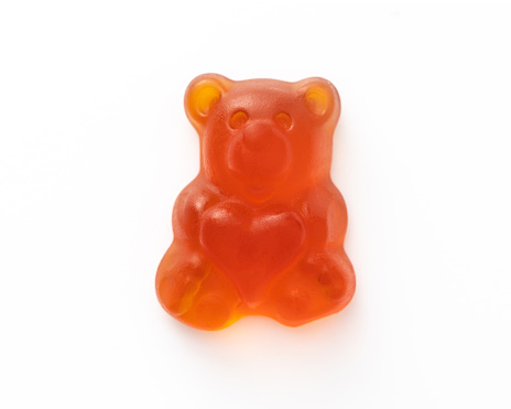 Brightly colored gummy bear on white background