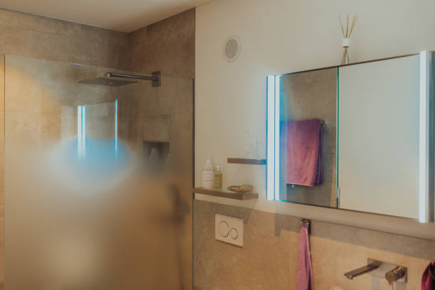 istock White sink on wood counter with a round mirror hanging above it. Bathroom interior. 1423540366