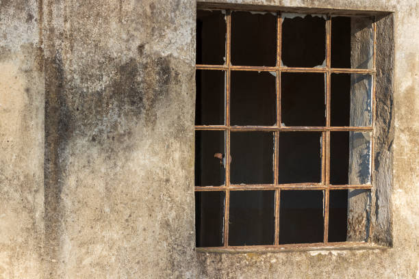 istock Barred window where the glass is broken. 1423540554