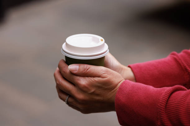 istock Coffee cup being held by a woman 1423543337