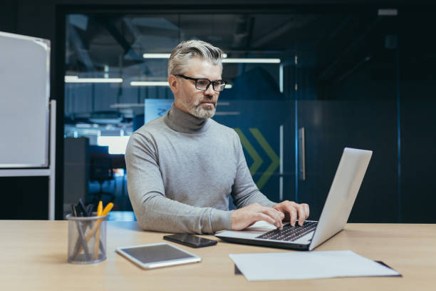 istock Experienced and mature successful businessman focused and serious man working inside office 1423544188
