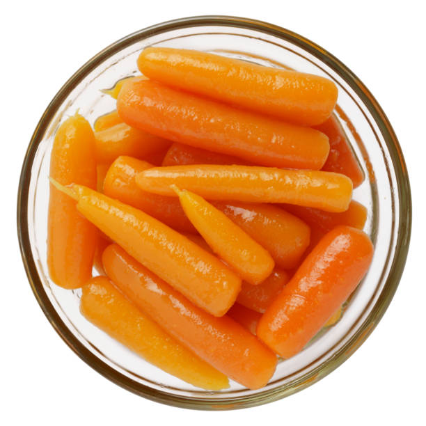 istock Boiled canned carrots in a bowl isolated on white background 1423545065