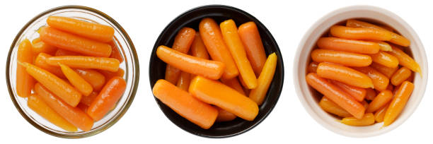 istock Boiled canned carrots in a bowl isolated on white background 1423545301