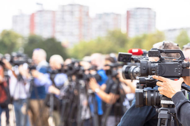 istock News conference. Filming media event with a video camera. 1423546828