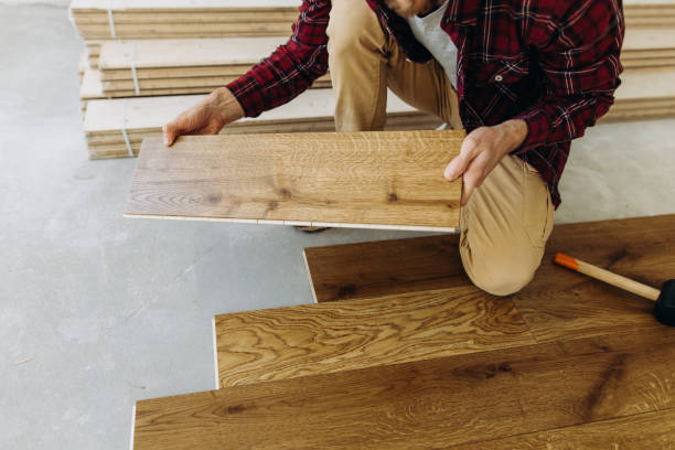 istock The man is going to install a parquet floor 1423549456