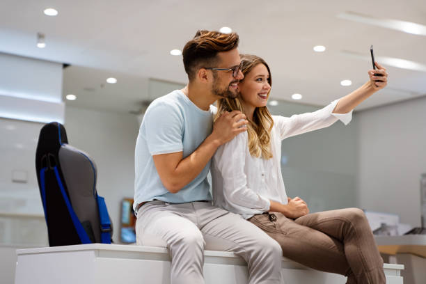 istock Young cheerful couple taking selfie together and having fun. Technology people concept 1423550084