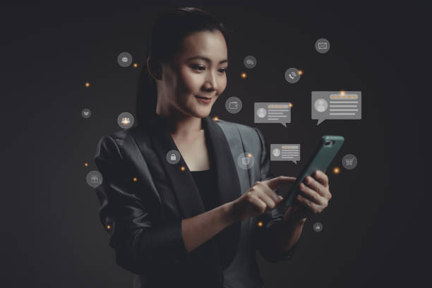istock Asian woman using smart phone for check feedback, reviews with comments icon hologram effect. 1423550328