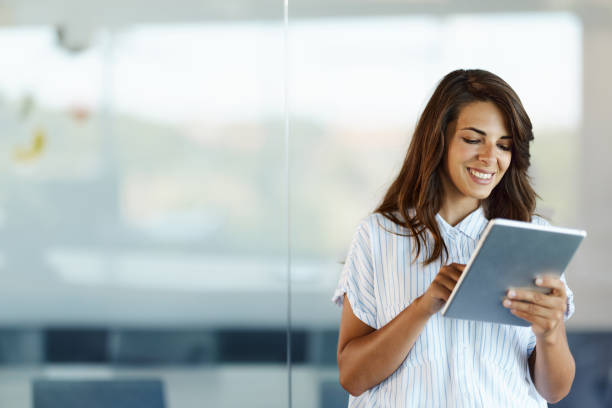istock Young happy businesswoman using digital tablet in the office. 1423550422