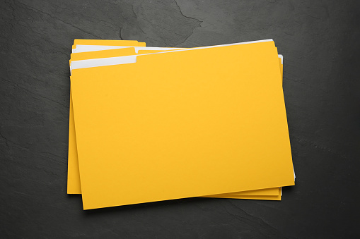 Yellow File Partition Yellow Files With Documents On Black Slate Table Top View Stock Photo ...
