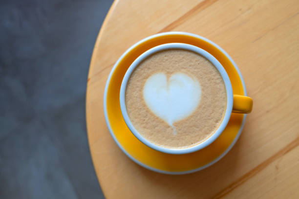 istock A cup of cappuccino on a wooden table. 1423550831