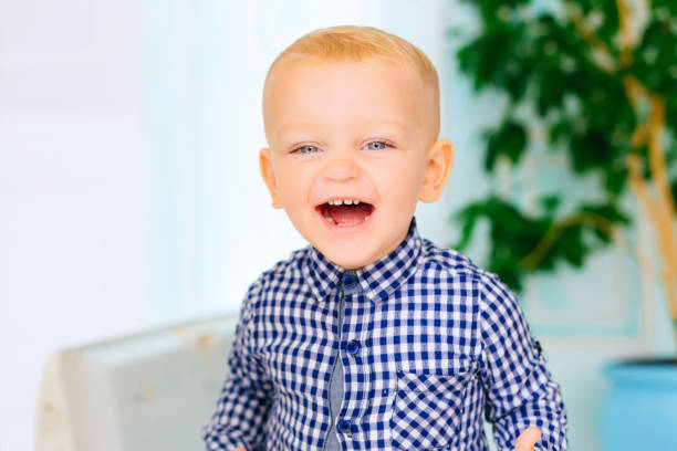 little boy smiles genuinely looking at the camera lens