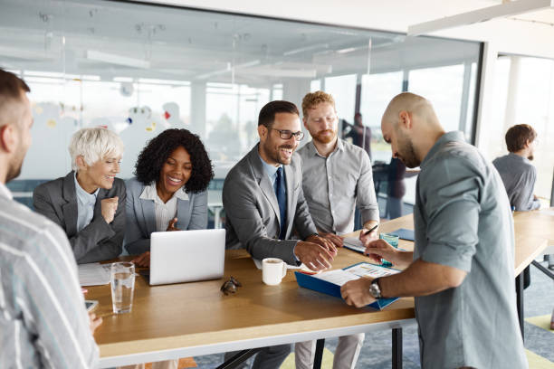 istock Group of happy entrepreneurs working in a modern office. 1423552518