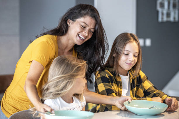 Teenage and little girl waiting for breakfast stock photo