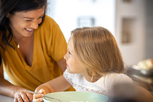 istock Mother and little daughter in the kitchen having breakfast 1423552807