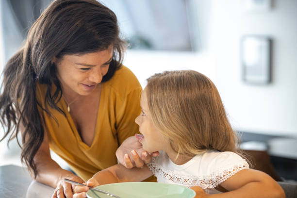 istock Mother and little daughter in the kitchen having breakfast 1423552986