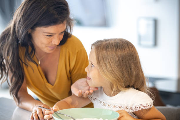 istock Mother and little daughter in the kitchen having breakfast 1423553023