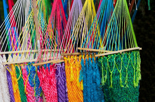 Mexican hammocks (hanging beds) with bright, vivid colors in an outdoors souvenir shop  at Chichen Itza, Mexico