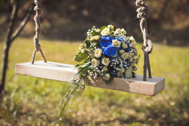 istock Colorful wedding bouquet on a wooden swing 1423554467