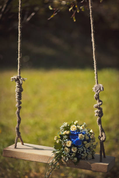 istock Colorful wedding bouquet on a wooden swing 1423554471