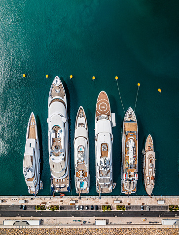 Aerial photo from a drone of a row of luxury super yachts moored in Port Vauban, Antibes, Cote D'Azur, France