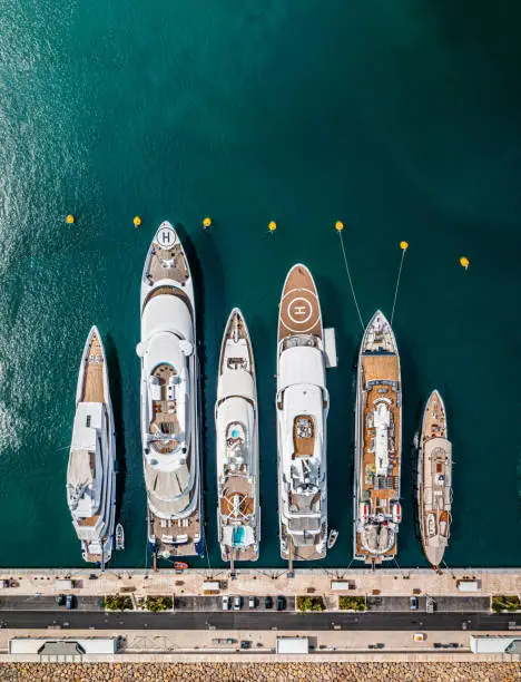 Aerial photo from a drone of a row of luxury super yachts moored in Port Vauban, Antibes, Cote D'Azur, France
