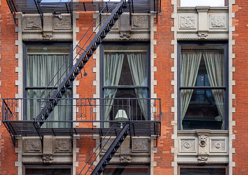 Lamp in a window as part of the façade of a residential building in central Manhattan