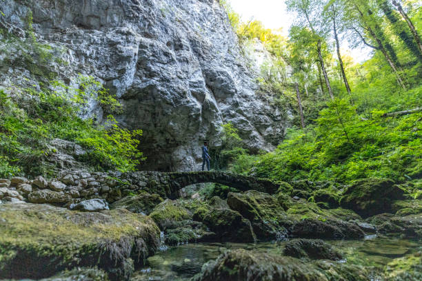 istock Businessman Standing On A Isolated Bridge In A Cave Complex 1423557339