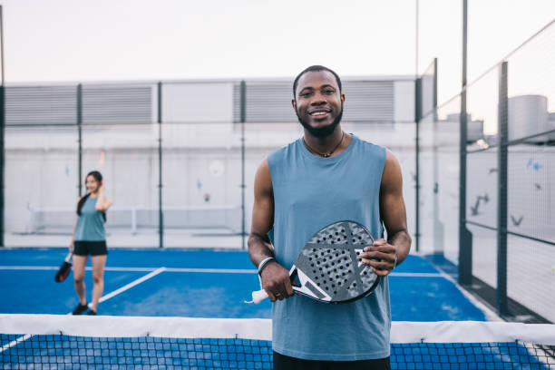 istock Positive paddle tennis player at rooftop court 1423558483