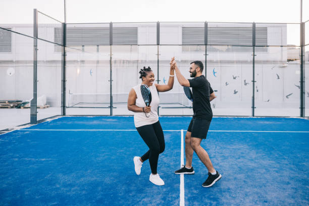 High five for successful paddle tennis match
