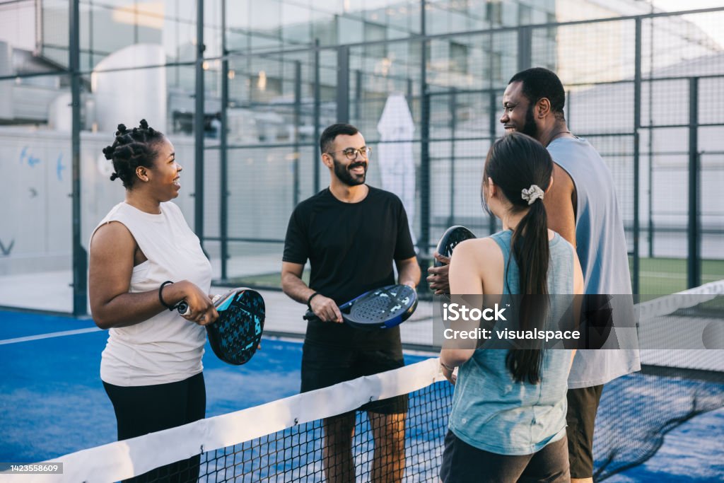 Paddle players greeting each other before match Group of paddle tennis players greeting each other before friendly match. Padel Stock Photo