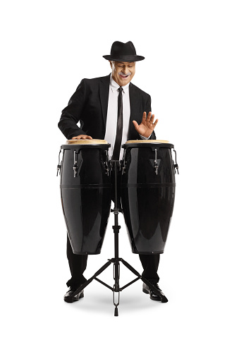 Elegant mature man playing conga drums isolated on white background