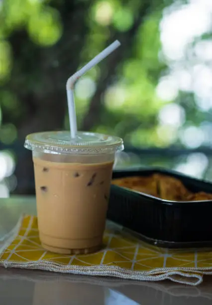 Photo of Iced coffee latte and breakfast in black box