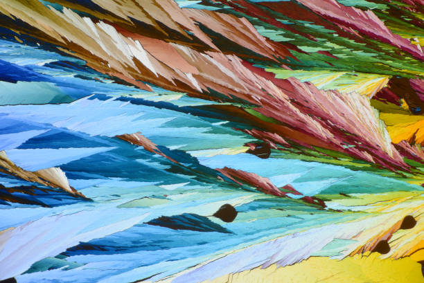 istock Colorful micro crystals in polarized light. Photo through a microscope 1423562435