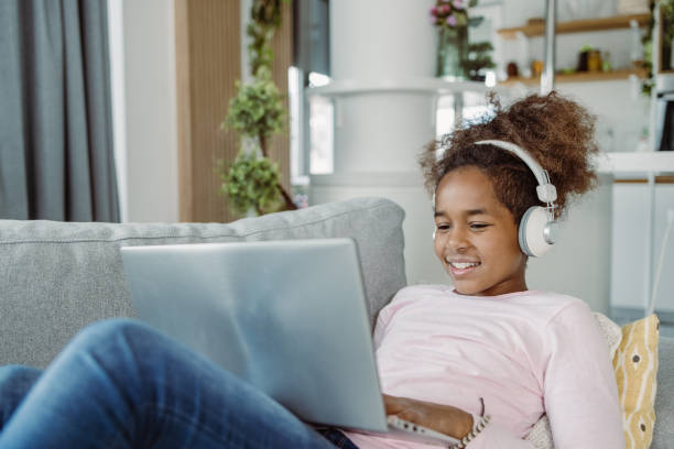istock Little girl using laptop at home 1423563785